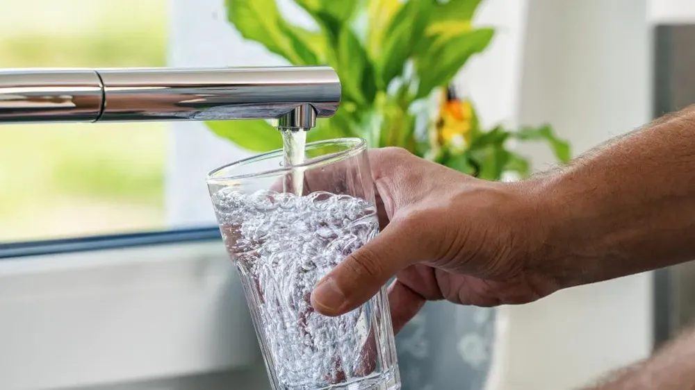 Filling a glass of water at the sink